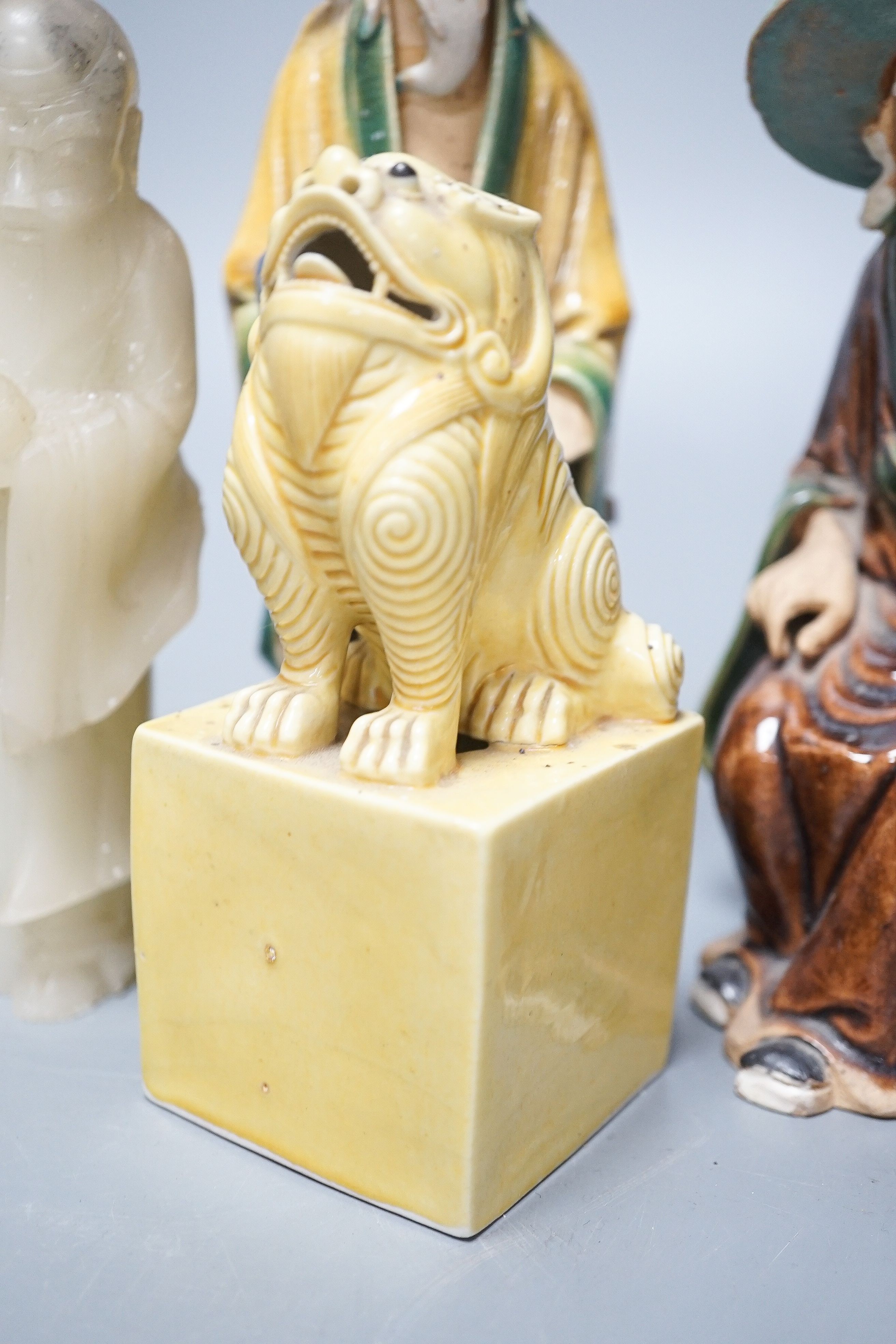 A Chinese glazed biscuit lion-dog seal, a Chinese blue and white tureen, width 18cm, two Shiwan figures and two teabowls, four saucers and a soapstone carving 20cm